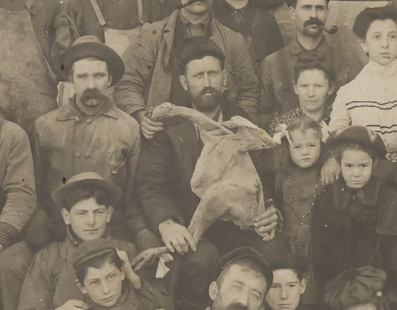 Lot 023 - Antique Boarded Occupational Photograph Of A Group Of Gruff Looking Laborers And Their Families, Likely On Thanksgiving, Note Men Displaying Turkey