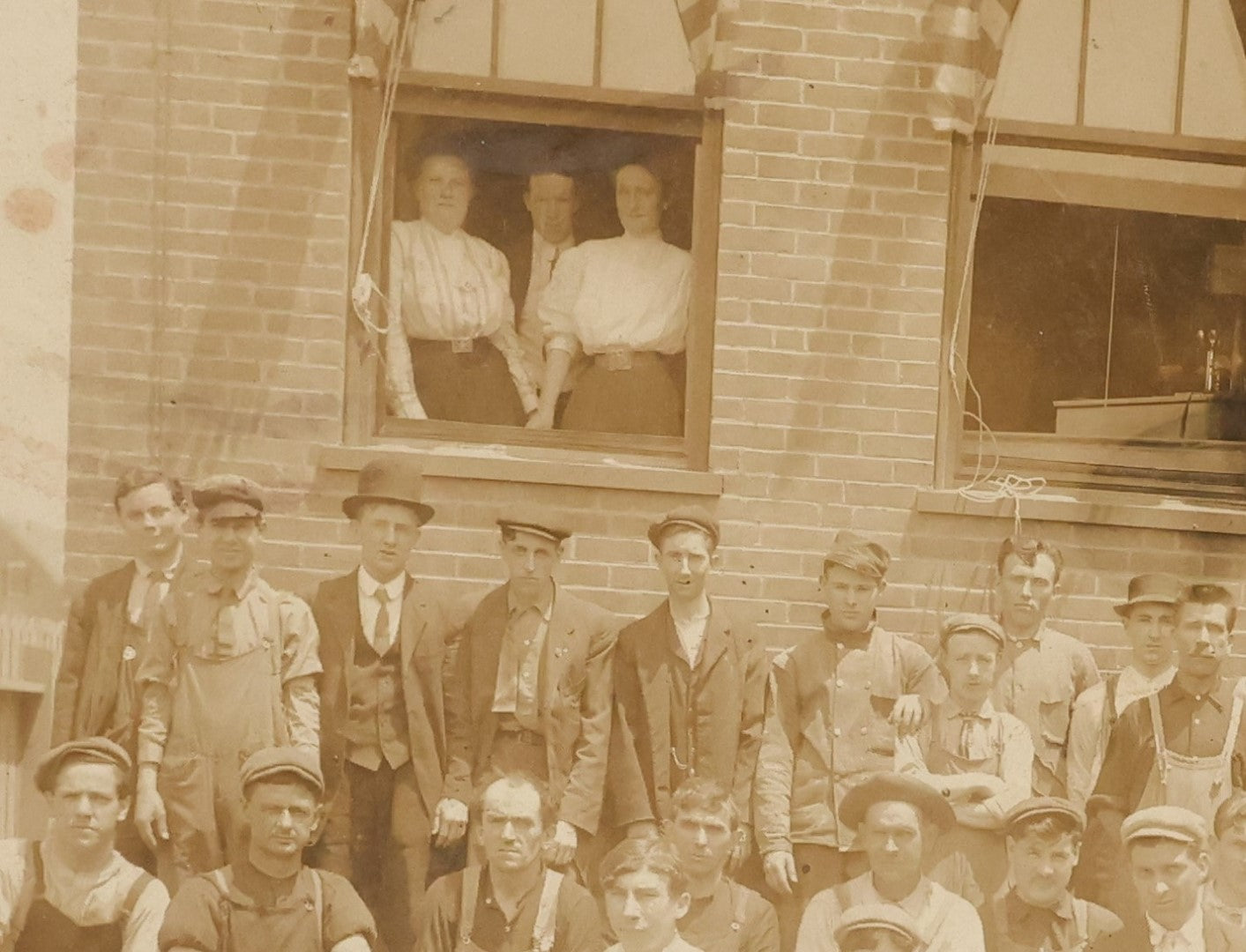 Lot 024 - Antique Boarded Occupational Photograph Of A Group Of Laborers Outside Of A Commercial Building, Note Ladies In Window, Striped Awnings