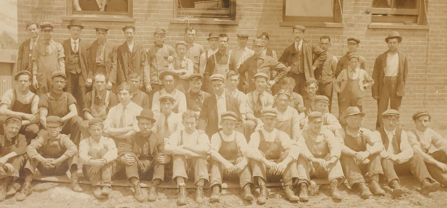 Lot 024 - Antique Boarded Occupational Photograph Of A Group Of Laborers Outside Of A Commercial Building, Note Ladies In Window, Striped Awnings