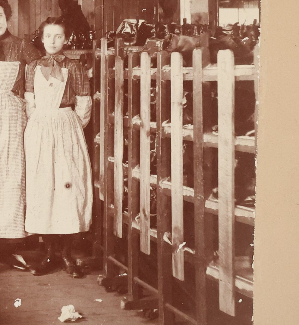 Lot 025 - Antique Boarded Occupational Photograph Of Four Women And Two Men Working In A Boot And Shoe Factory, Many Shoes Visible In Photo