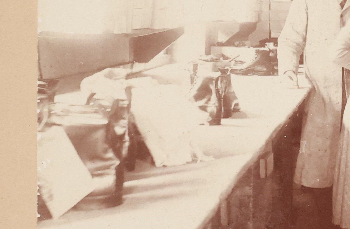 Lot 025 - Antique Boarded Occupational Photograph Of Four Women And Two Men Working In A Boot And Shoe Factory, Many Shoes Visible In Photo