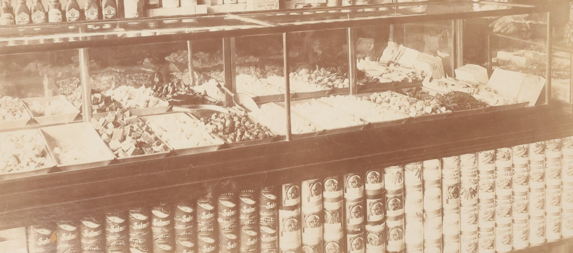 Lot 026 - Antique Boarded Occupational Photograph Of A Shopkeeper In A General Store, Identified As C.R. Johnson, 1907, Products Visible, Including Campbell's Soup Cans