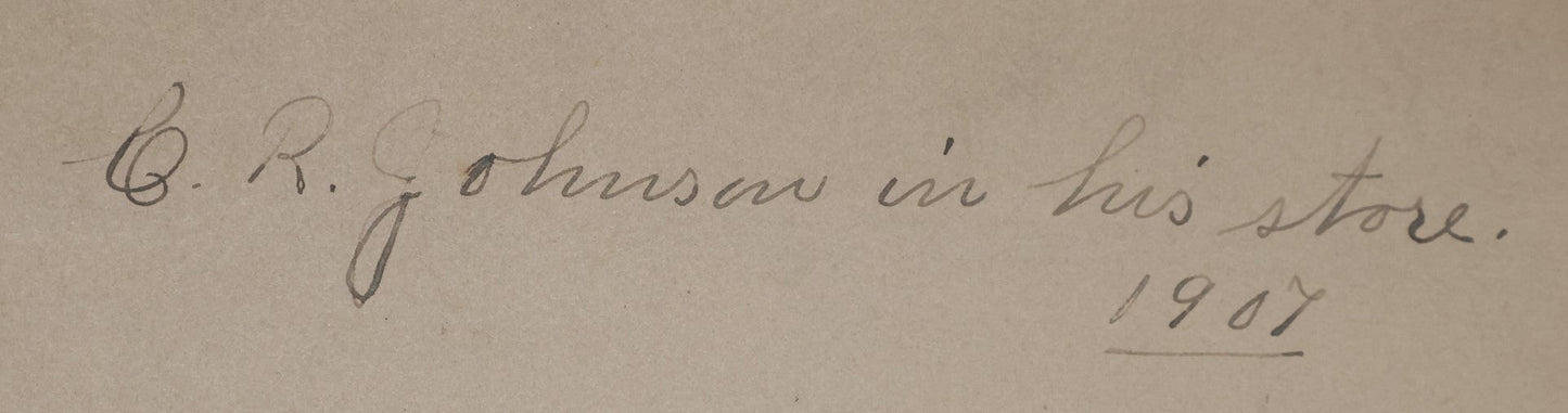 Lot 026 - Antique Boarded Occupational Photograph Of A Shopkeeper In A General Store, Identified As C.R. Johnson, 1907, Products Visible, Including Campbell's Soup Cans