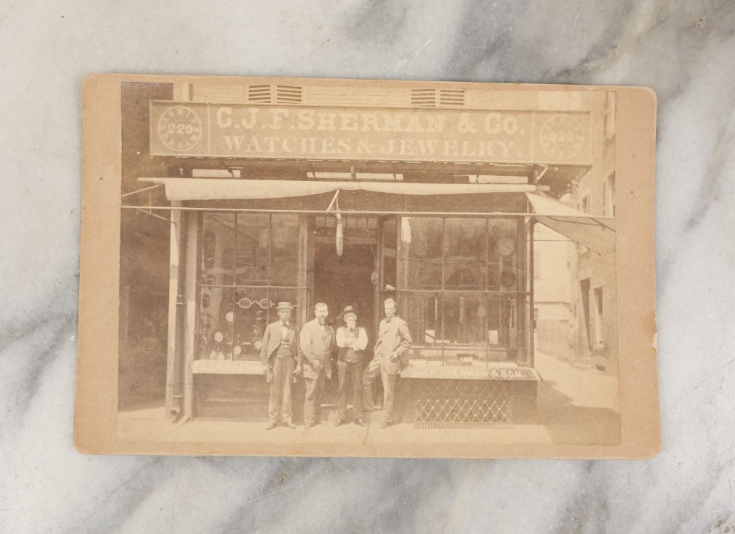 Lot 028 - Antique Cabinet Card Occupational Photograph Of C.J.F. Sherman & Co., Watches And Jewelry, With Men Outside, Note Optometrist Glasses Sign In Window, By Rand & Gould, Photographers, Boston