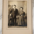 Lot 029 - Vintage Boarded Photograph Of A Young Couple With Dwarfism, Man And Woman, Well Dressed, Next To Ornate Chair