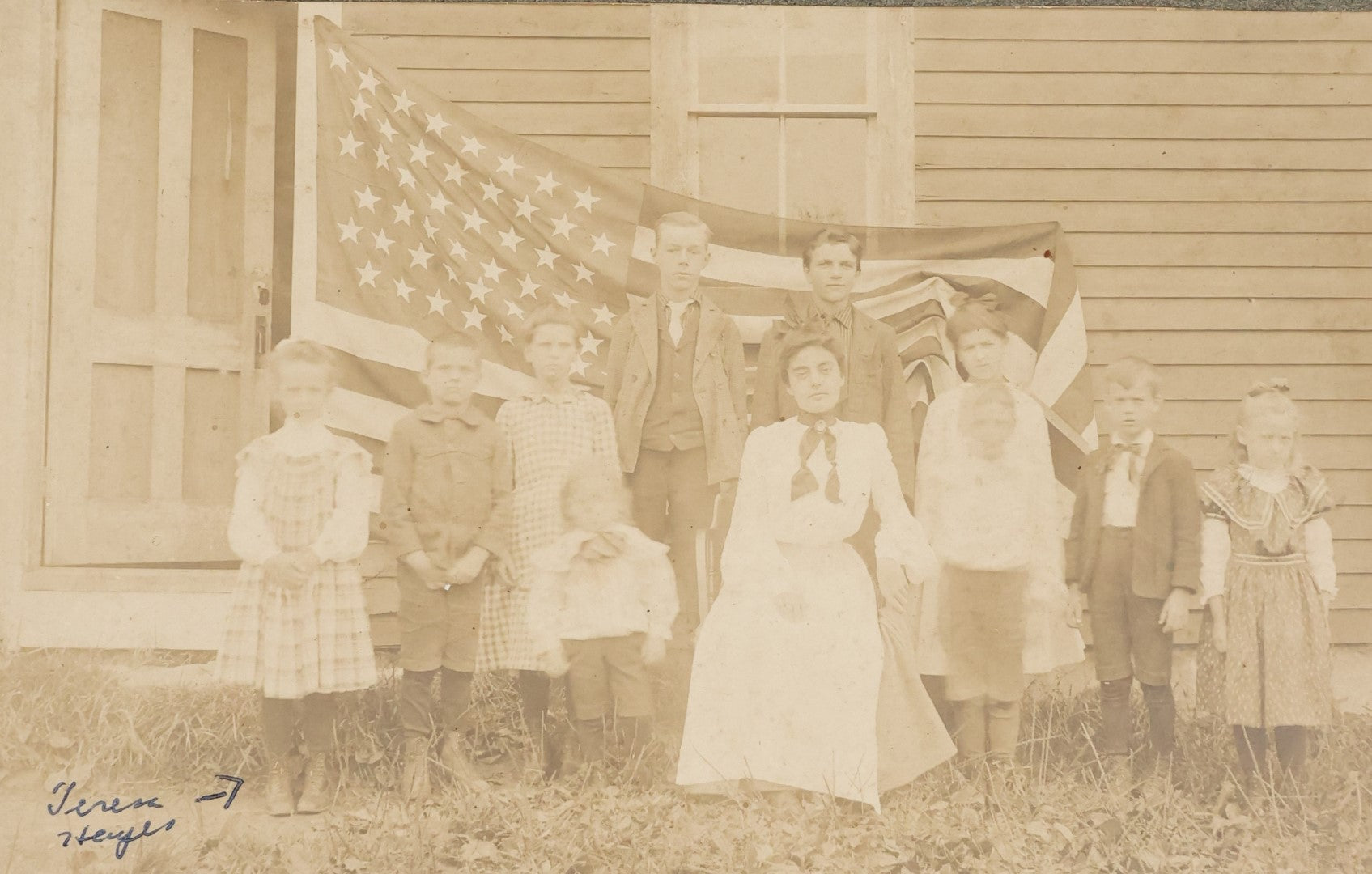 Lot 030 - Antique Boarded Photograph Of A Woman And Children In Front Of As 48 Star American Flag, Early 20th Century, Little Girl Identified As Teresa Heyes