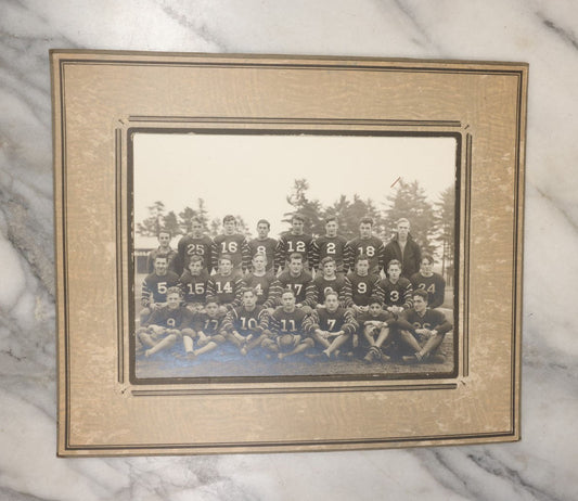 Lot 034 - Vintage Boared Photograph Of An High School Boys American Football Team, In Numbered Uniforms, No Location Given, Young Coach In Photo