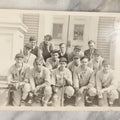 Lot 035 - Vintage Snapshot Photograph Of A Boys High School Baseball Team, Sitting On Front Stoop Of Building, With Coach
