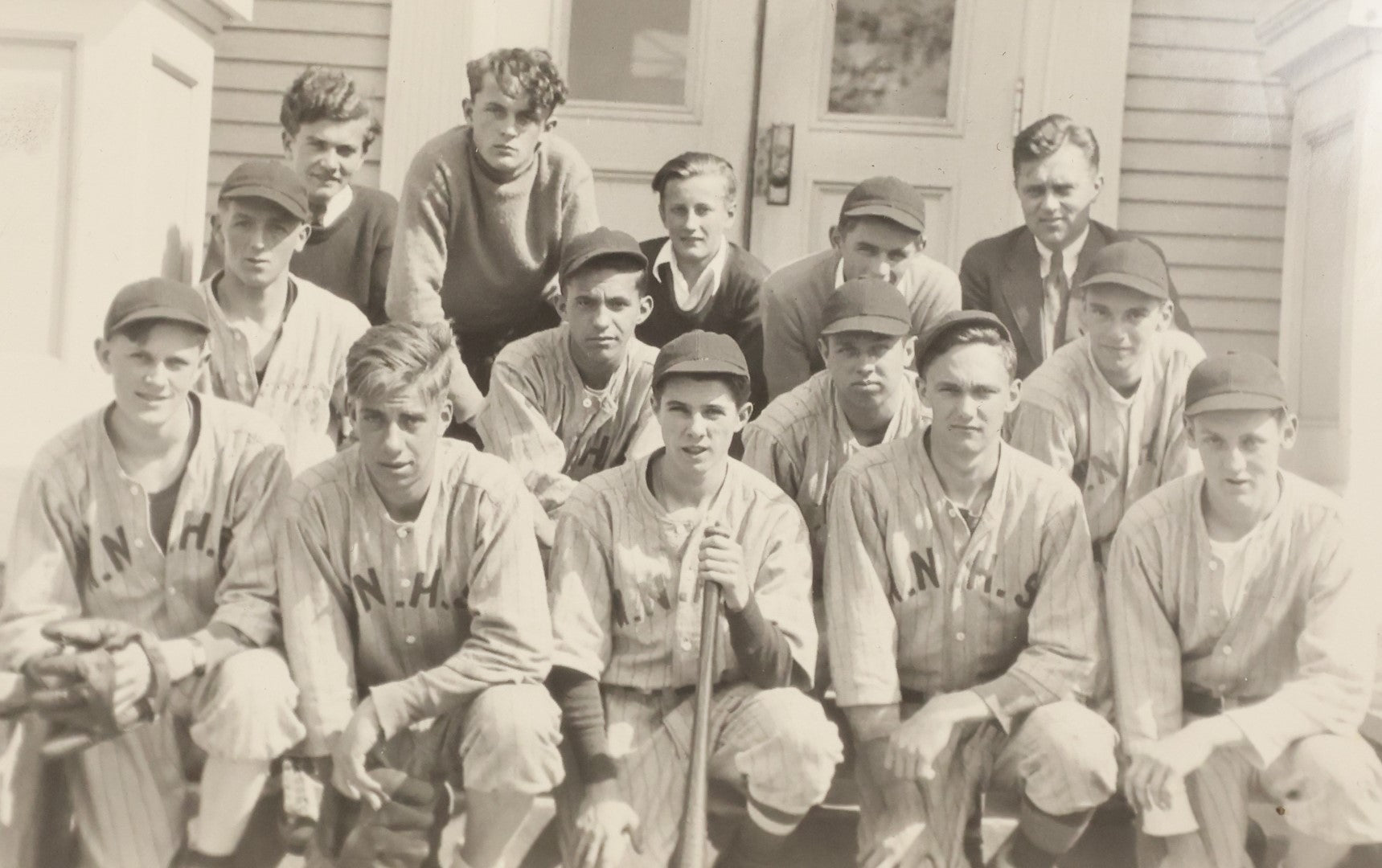 Lot 035 - Vintage Snapshot Photograph Of A Boys High School Baseball Team, Sitting On Front Stoop Of Building, With Coach