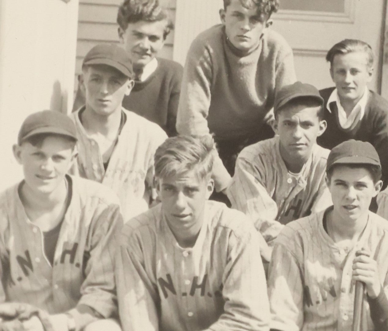 Lot 035 - Vintage Snapshot Photograph Of A Boys High School Baseball Team, Sitting On Front Stoop Of Building, With Coach