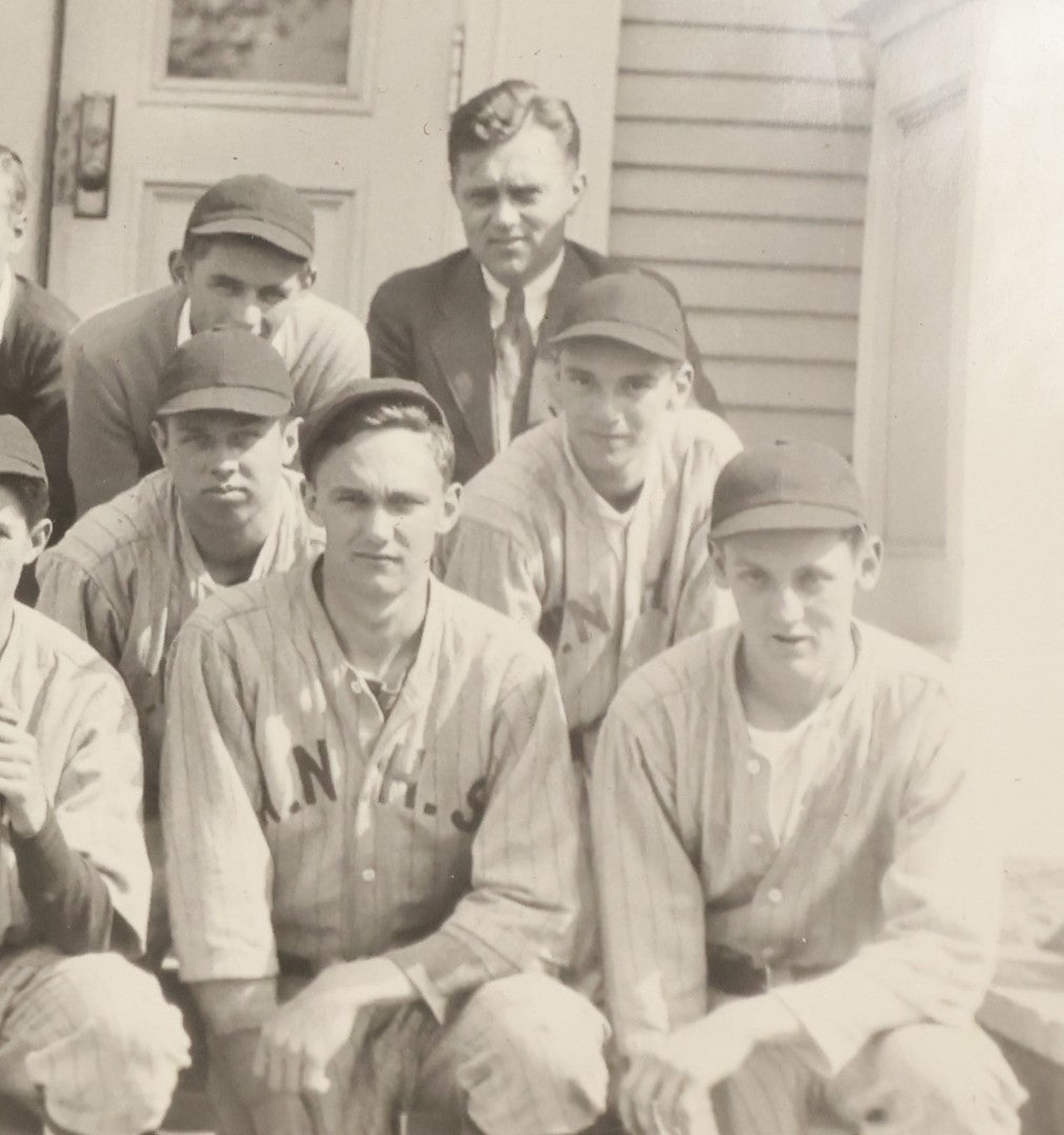 Lot 035 - Vintage Snapshot Photograph Of A Boys High School Baseball Team, Sitting On Front Stoop Of Building, With Coach