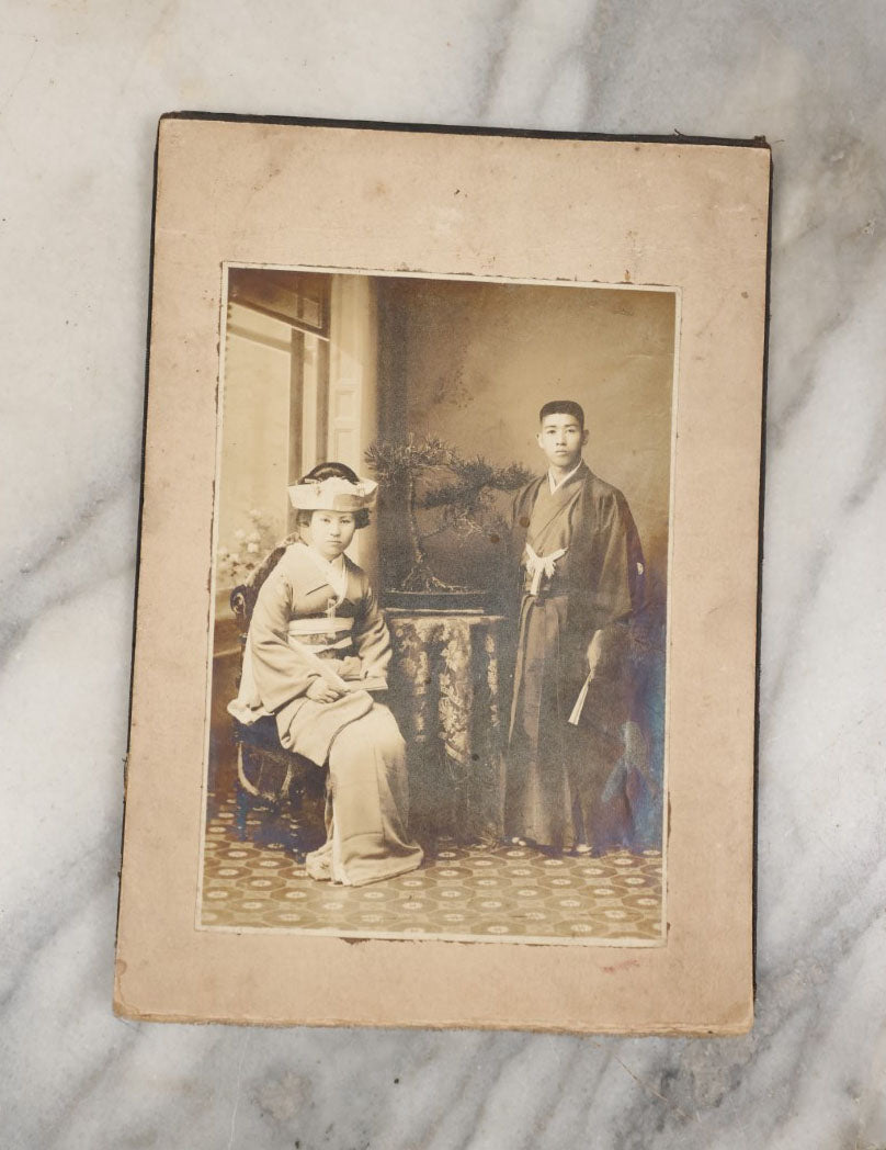 Lot 036 - Antique Boarded Photo Of A Young Chinese Couple, Man And Woman In Traditional Dress, Text On Back Of Board Translates To "Photo Post"