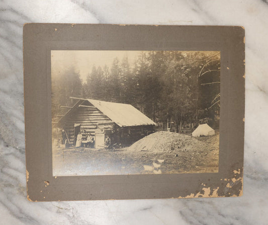 Lot 037 - Antique Boarded Photograph Of The Homestead Of Andrew Young, Kalispell, Montana, With Root Cellar And Chicken Tent, Dog In Photo, Dated September 12, 1897