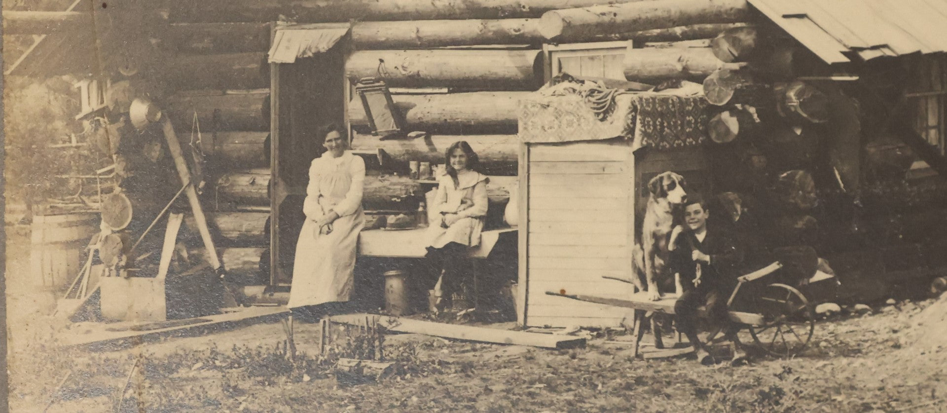 Lot 037 - Antique Boarded Photograph Of The Homestead Of Andrew Young, Kalispell, Montana, With Root Cellar And Chicken Tent, Dog In Photo, Dated September 12, 1897