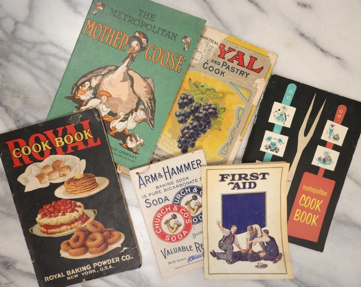 Lot 087 - Grouping Of Six Vintage Booklets Including The Metropolitan Mother Goose, Cook Books, Arm And Hammer Advertisement, First Aid, And More