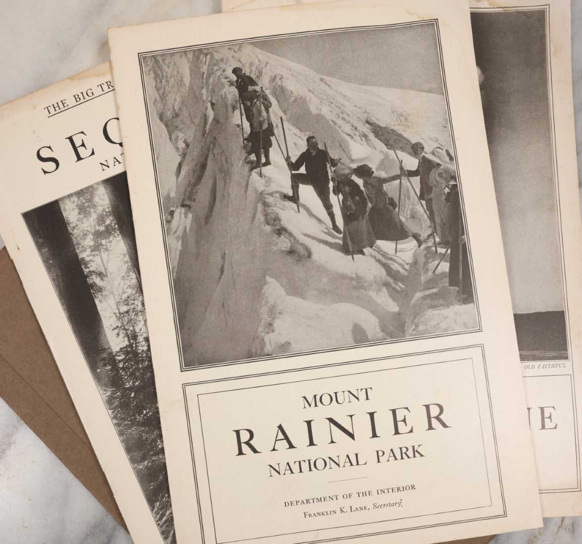 Lot 115 - National Parks Portfolio Folder With Booklets On Mount Rainier, Equoia, And Yellowstone National Parks, Published By The Department Of The Interior