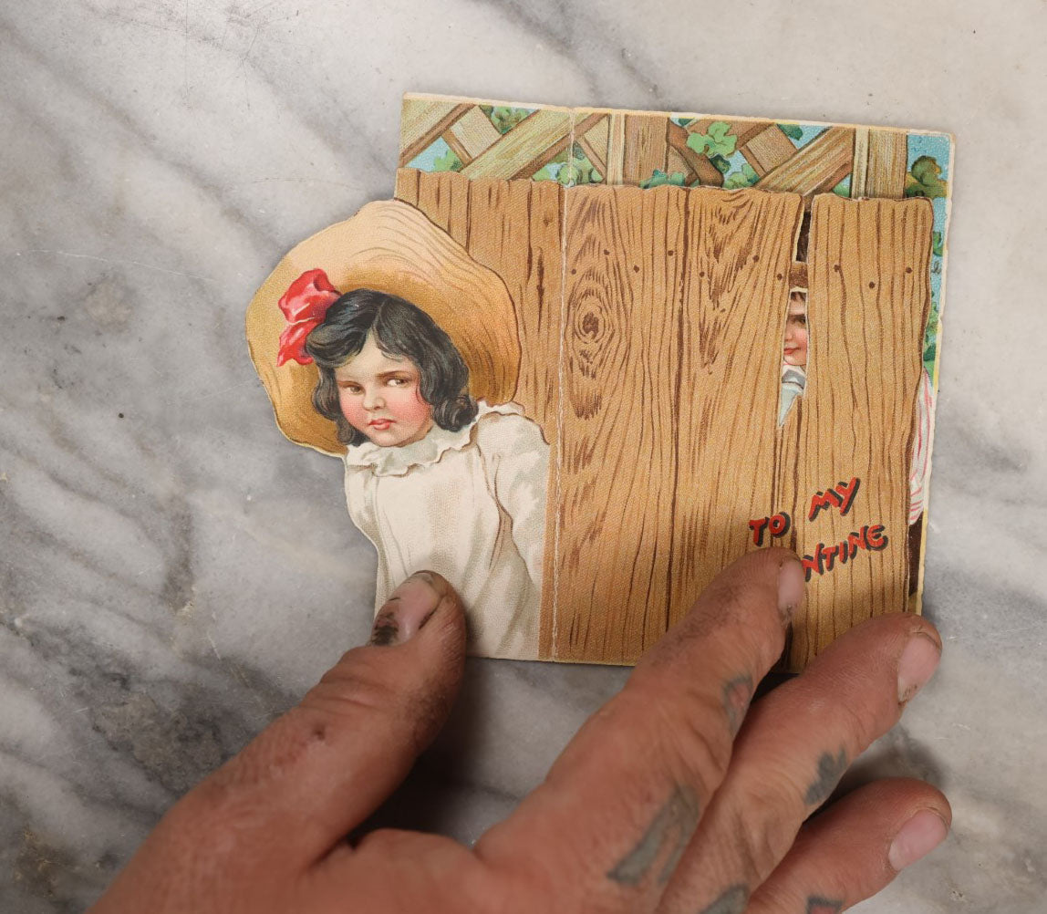 Lot 132 - Single Valentine's Card, Boy Flirting With Girl Behind Fence, Other Girl Looking On Jealousy, By Raphael Tuck & Sons Ltd., Printed In Germany