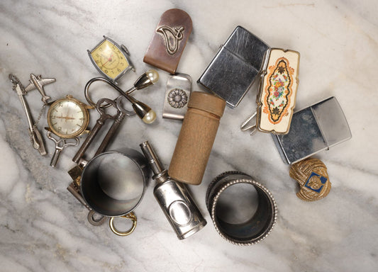 Lot 141 - Junk Drawer Grouping, 10+ Pieces Of Miscellaneous Metal And More Objects, Including Two Zippo Lighters, Cub Scout Neckerchief Tie, Napkin Rings, Keys, Watches, And More
