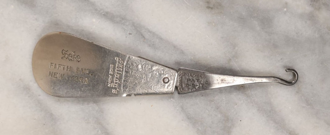 Lot 152 - Single Junk Drawer Finding, Antique Folding Button Hook Tool And Shoehorn, Advertising Saks Fifth Avenue, New York, Patented 10-9-1917