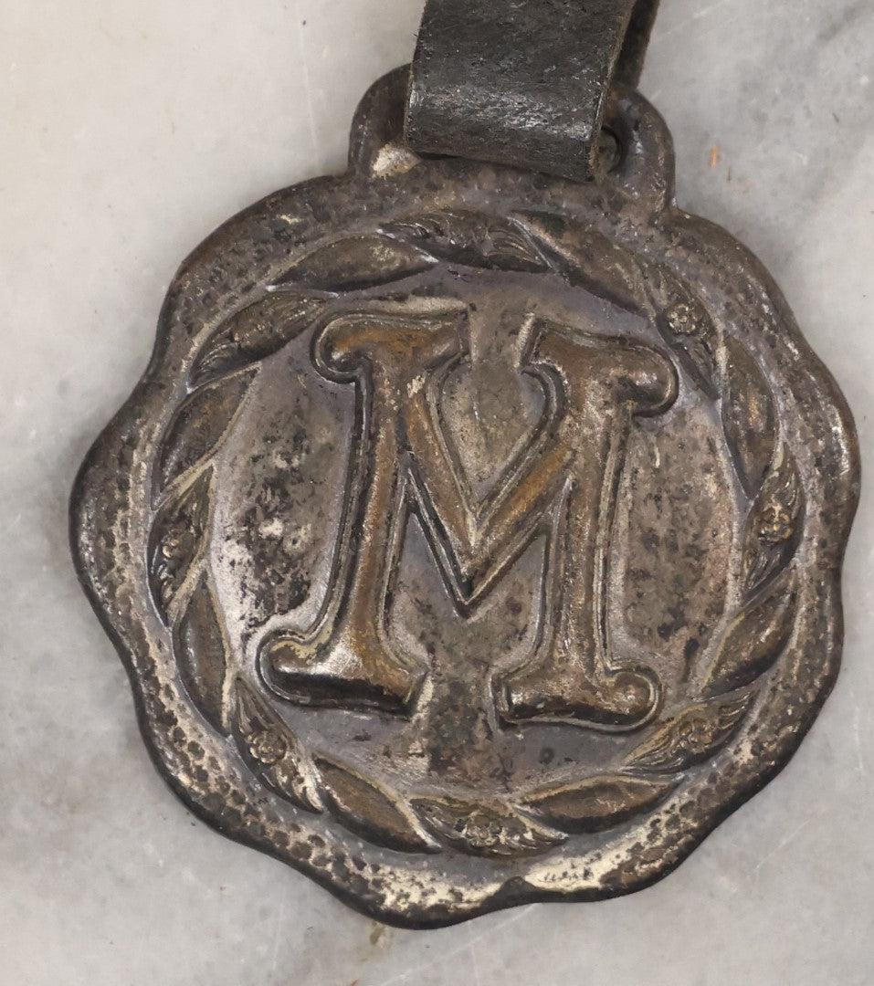 Lot 154 - Single Junk Drawer Finding, Letter "M" Watch Fob With Leather Strap