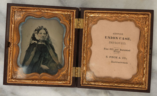 Lot 014 - Antique 1/6th Plate Ambrotype Photograph Of A Woman In A Hooded Cape With Bonnet, In Double Union Case By S. Peck & Co., Manufacturers, Note Scuffs, Scratches To Photo