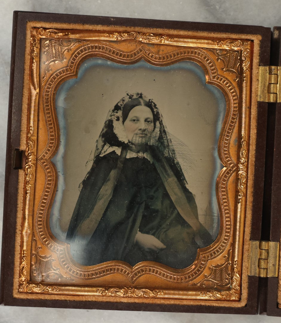 Lot 014 - Antique 1/6th Plate Ambrotype Photograph Of A Woman In A Hooded Cape With Bonnet, In Double Union Case By S. Peck & Co., Manufacturers, Note Scuffs, Scratches To Photo