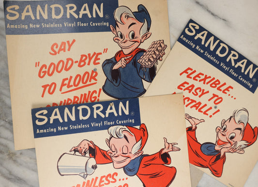 Lot 168 - Grouping Of Three Vintage Advertisements For Sandran Stainless Vinyl Floor Covering, With Elf Character