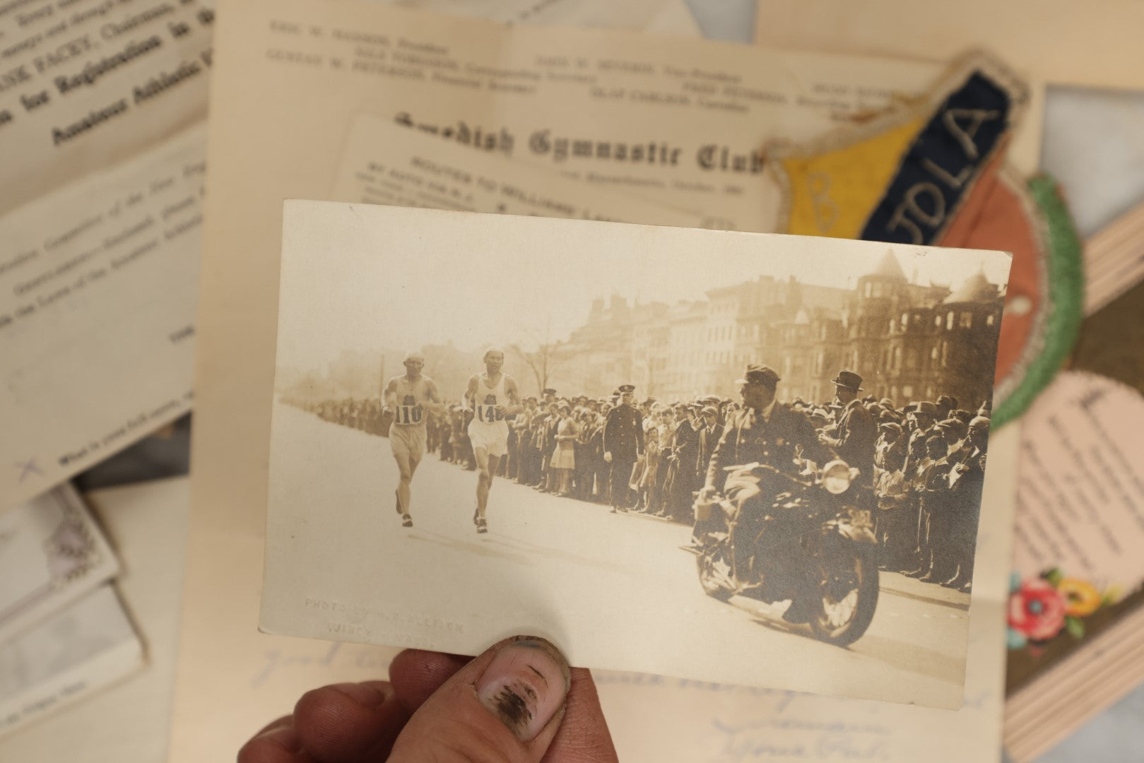 Lot 183 - Estate Ephemera Grouping Related To Boston Swedish Gymnastic Club Posse, Circa 1930s, Including Chocolate Box Found In, Includes Map Of New York City, Real Photo Postcard Of Motorcycle Cop And Boston Marathon, Hand Made Patch, Etc, As Found