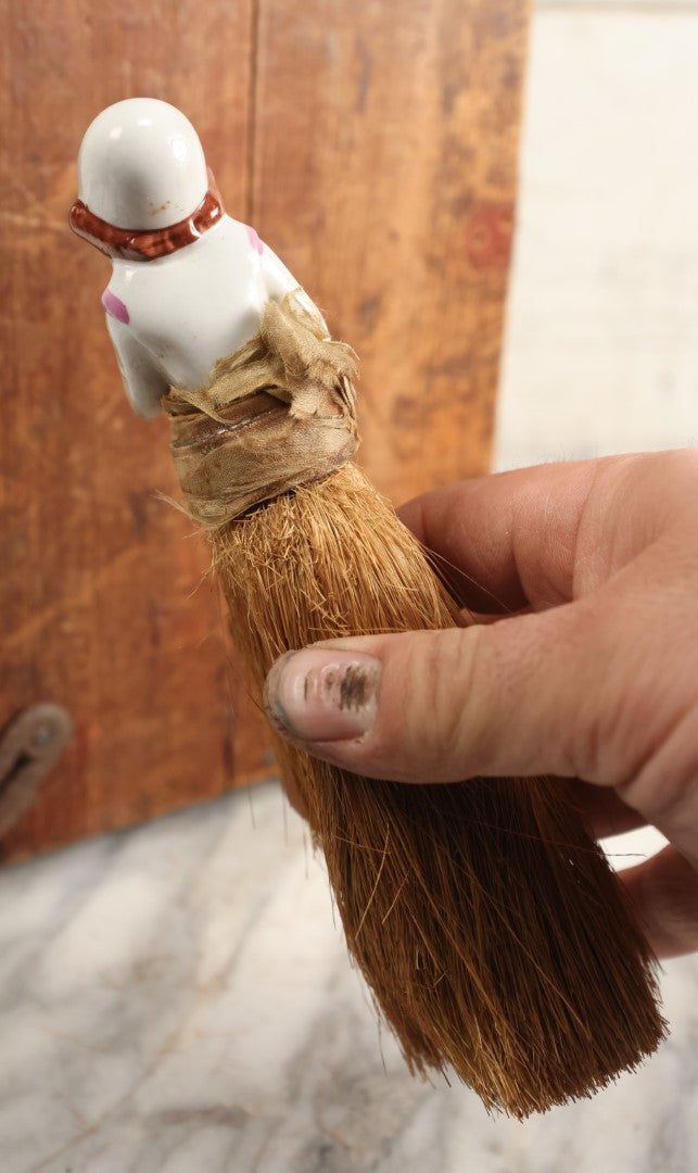 Lot 204 - Porcelain Flapper Woman Straw Dresser Brush, Hand Painted With Pink Detailing, Note Somewhat Loose