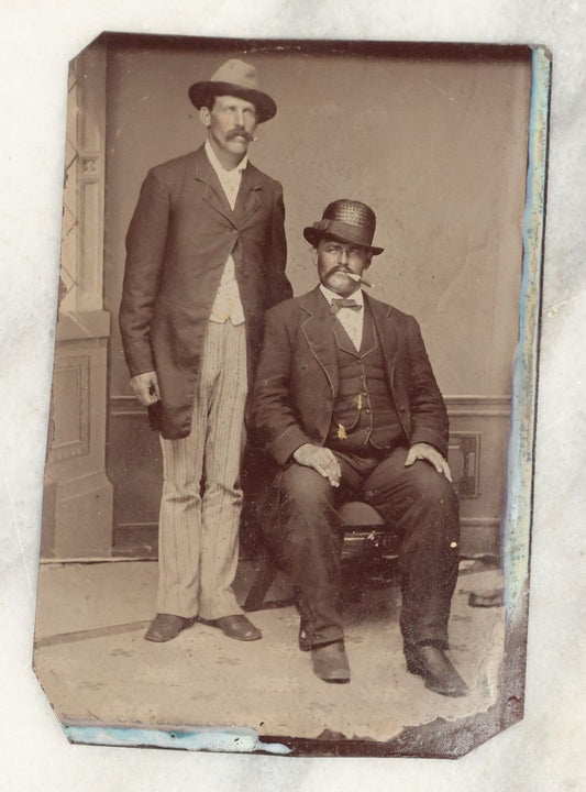 Lot 018 - Single Antique Tintype Photograph Of Two Burly Men In Hats Smoking Cigars, One Seated, One Standing