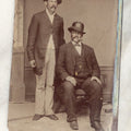 Lot 018 - Single Antique Tintype Photograph Of Two Burly Men In Hats Smoking Cigars, One Seated, One Standing
