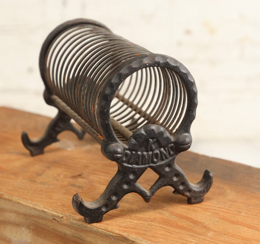 Lot 208 - Vintage Cast Iron Letter Spring Coil Letter Holder With Legs, Boots, By K. Diamond