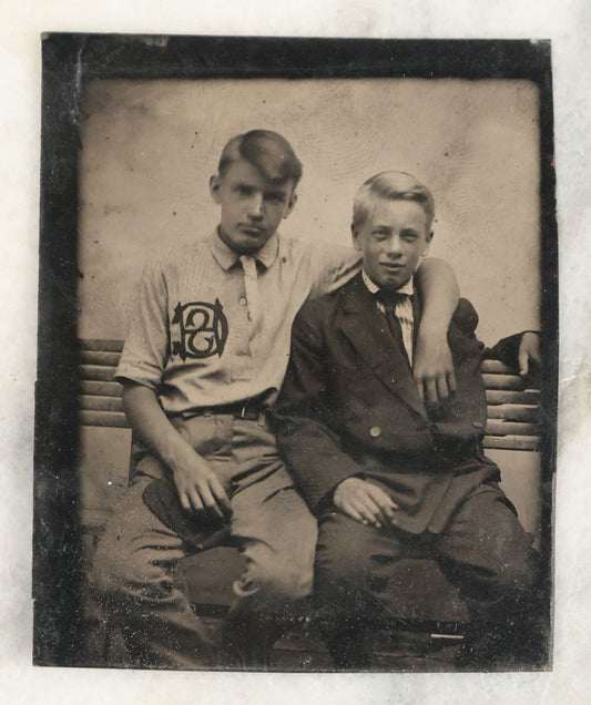 Lot 020 - Single Antique Tintype Photograph Of Two Young Boys On A Bench, One With A Monogrammed Jersey, Appears To Say C.H.S., Other In Suit