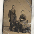 Lot 021 - Single Antique Tintype Photograph Of A Couple And Their Curly Haired Black Dog Seated Between Them, Note Bends, Creases