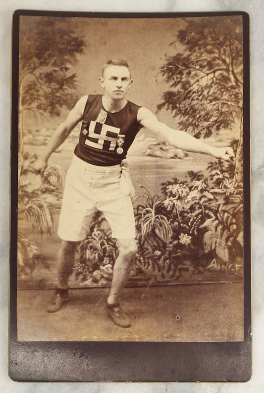 Lot 028 - Antique Cabinet Card Photograph Of A Late 19th Century Athlete, Likely Track And Field, Wearing A Shit And Badges With A Swastika "Whirling Logs" Good Luck Insignia, T.H. Pickles, Photographer, East Cambridge, Massachusetts, See Notes