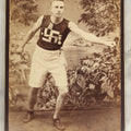 Lot 028 - Antique Cabinet Card Photograph Of A Late 19th Century Athlete, Likely Track And Field, Wearing A Shirt And Badges With A Swastika "Whirling Logs" Good Luck Insignia, T.H. Pickles, Photographer, East Cambridge, Massachusetts, See Notes