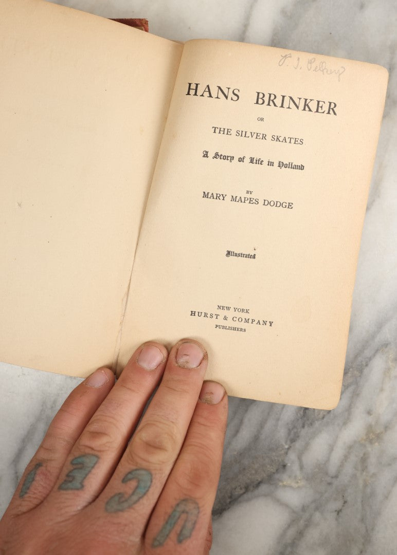Lot 035 - "Hans Brinker Or The Silver Skates: A Story Of Life In Holland" Antique Book By Mary Mapes Dodge, Published By Hurst & Company, New York, With Baseball Player And Football Player On Cover