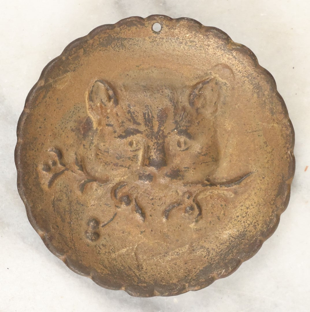 Lot 069 - Small Antique Cast Metal Cat Head Pendant Trinket Or Change Tray, Cat Has Flowers In Mouth, Hole At Top For Hanging Or Wearing