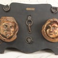 Lot 093 - Antique Chalkware Friar Heads Wall Hanging Match Safe And Match Strike, Matches Go In Friar's Heads, On Wooden Plaque With Metal Adornments, Note Various Chipping Losses