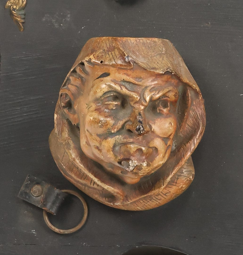 Lot 093 - Antique Chalkware Friar Heads Wall Hanging Match Safe And Match Strike, Matches Go In Friar's Heads, On Wooden Plaque With Metal Adornments, Note Various Chipping Losses