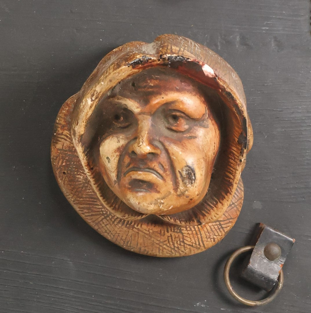 Lot 093 - Antique Chalkware Friar Heads Wall Hanging Match Safe And Match Strike, Matches Go In Friar's Heads, On Wooden Plaque With Metal Adornments, Note Various Chipping Losses