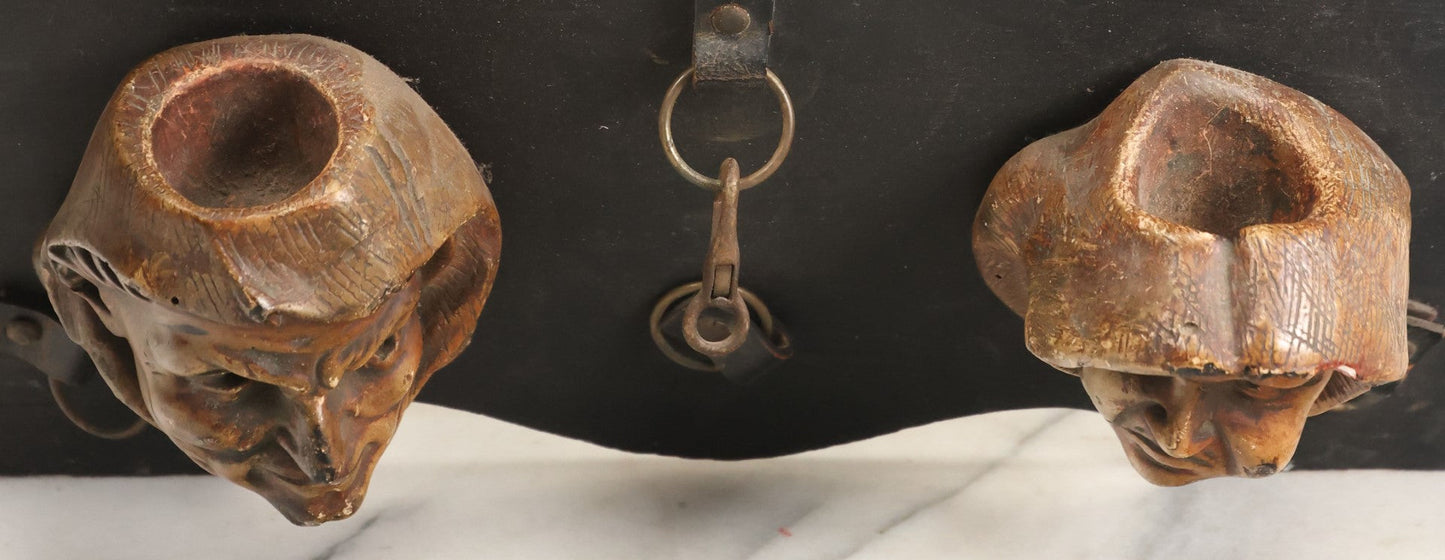 Lot 093 - Antique Chalkware Friar Heads Wall Hanging Match Safe And Match Strike, Matches Go In Friar's Heads, On Wooden Plaque With Metal Adornments, Note Various Chipping Losses