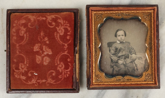 Lot 096 - Antique 1/6th Plate Daguerreotype Photograph Of A Young Boy In A Polka Dot Shirt And Checkered Pants, Resting Arm On Table With Paisley Drapery, In Seperated Complete Leatherette Case