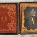 Lot 097 - Antique 1/6th Plate Daguerreotype Photograph Of An Older Man With White Hair, Wearing Suit With Black Bow Tie, In Repaired Leatherette Case