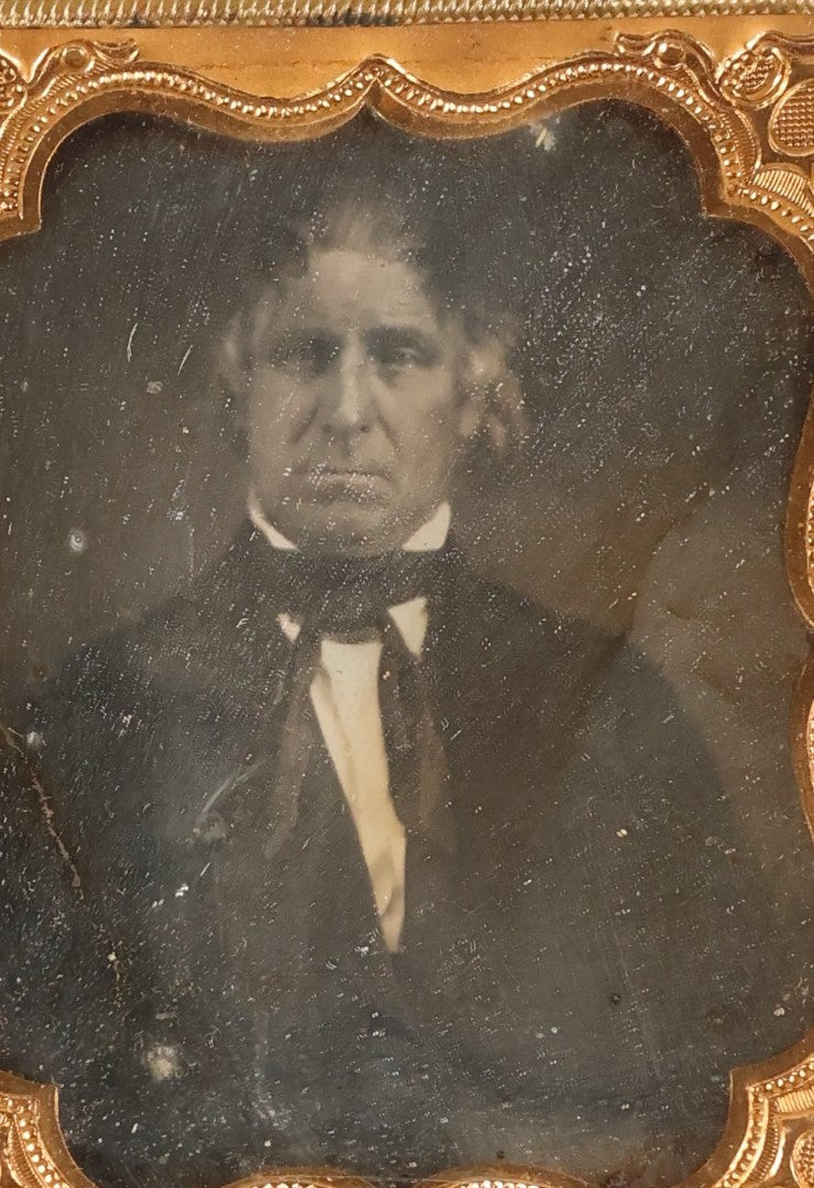 Lot 097 - Antique 1/6th Plate Daguerreotype Photograph Of An Older Man With White Hair, Wearing Suit With Black Bow Tie, In Repaired Leatherette Case