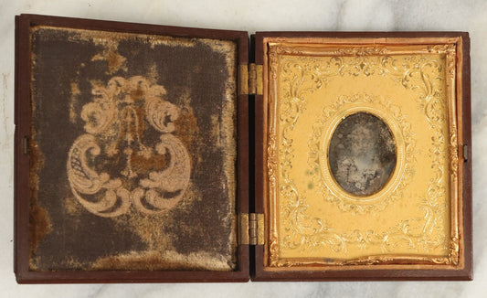 Lot 098 - Antique 1/6th Plate Daguerreotype Photograph Of A Young Baby In A Thermoplastic Case With Deep Brass Mat, Note Heavy Wear, Degradation To Photo, But Baby's Face Still Visible