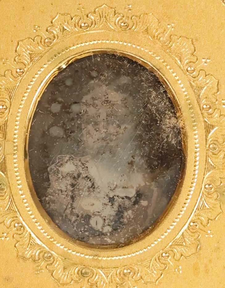 Lot 098 - Antique 1/6th Plate Daguerreotype Photograph Of A Young Baby In A Thermoplastic Case With Deep Brass Mat, Note Heavy Wear, Degradation To Photo, But Baby's Face Still Visible