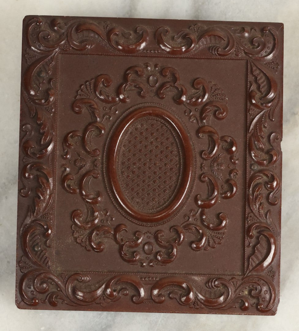 Lot 098 - Antique 1/6th Plate Daguerreotype Photograph Of A Young Baby In A Thermoplastic Case With Deep Brass Mat, Note Heavy Wear, Degradation To Photo, But Baby's Face Still Visible