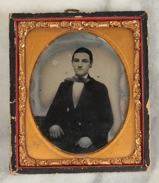 Lot 102 - Antique 1/6th Plate Ruby Ambrotype Photograph Of A Young Man With A Wide Bowtie In A Wooden Wall Hanging Half Case
