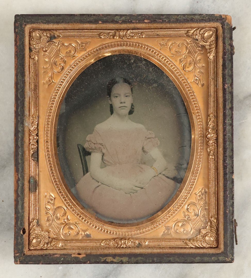 Lot 110 - Antique 1/6th Plate Ambrotype Of A Pretty Young Girl In A Pink Tinted Off-The-Shoulders Dress, Gold Tinted Bracelet, In Half Leatherette Case